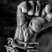 Arm in chains and the hand is closed as a fist, struggle free from oppression and tyranny ,
